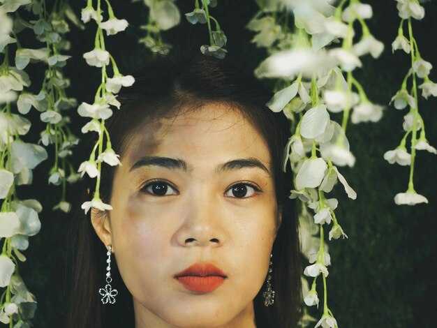 Foto close-up portret van vrouw te midden van witte bloemen