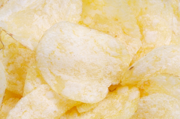 Close-up of potato chips on white background 