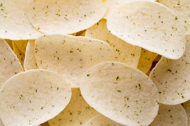 Close up potato chips on wood top view background.