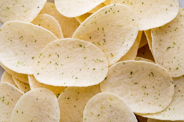 Close up potato chips on wood top view background.