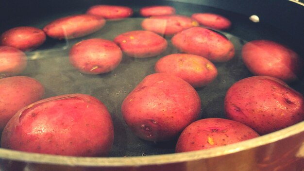 Close-up of potatoes floating on water inside container