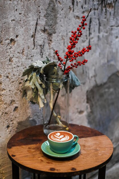 Close-up of potted plant on table against wall