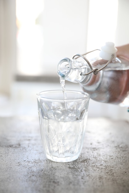 close up pouring water to glass