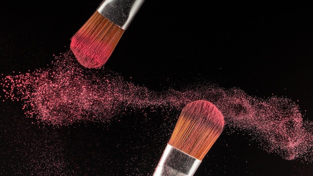 Close up powder splash and brush for makeup artist or beauty blogger in black background