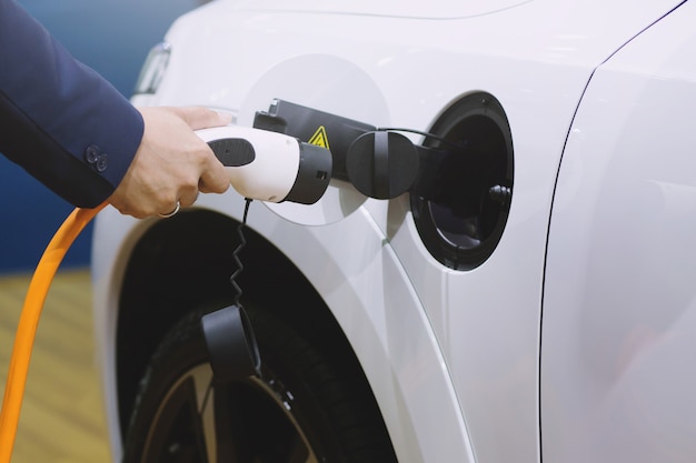 Close up of power supply plugged into an electric car being charged.