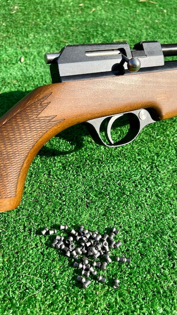 Close up of a practice rifle with lead ammunition on artificial grass