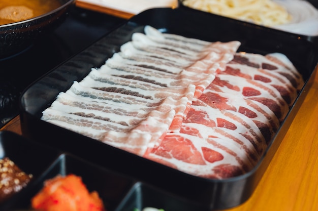 Close up Premium Rare Slices Kurobuta pork with high-marbled texture.