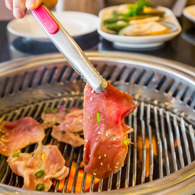 Close-up of preparing food on barbecue grill