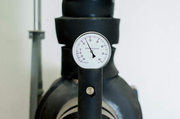 Close-up of pressure gauge against wall