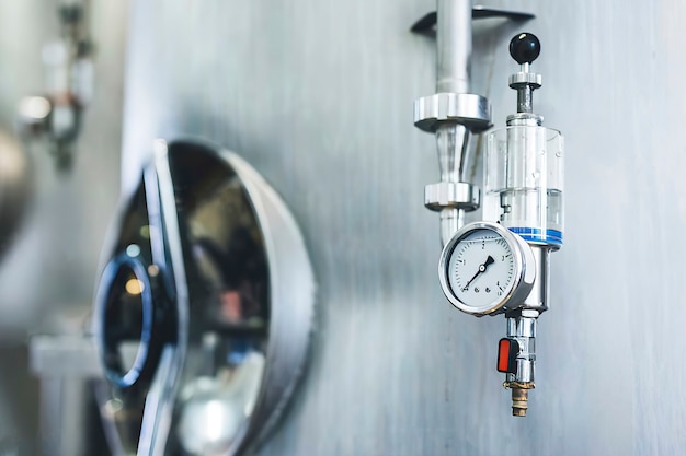 Close-up of pressure gauge attached on storage tank at brewery