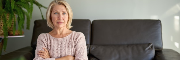 Close up Pretty Adult Woman Sitting on Sofa Looking at the Camera.