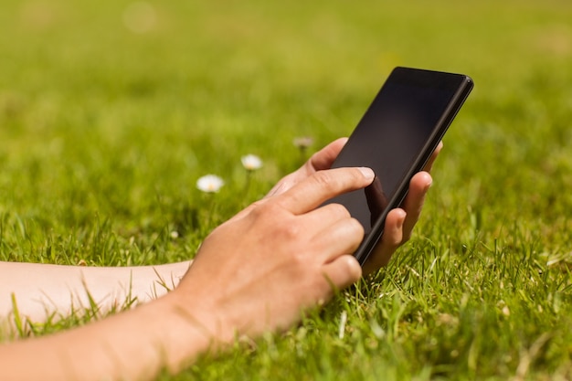 Close up of a pretty redhead holding her mobile phone