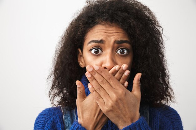 Close up of a pretty shocked african woman wearing sweater standing isolated, c