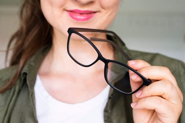 Photo close-up pretty woman holding glasses