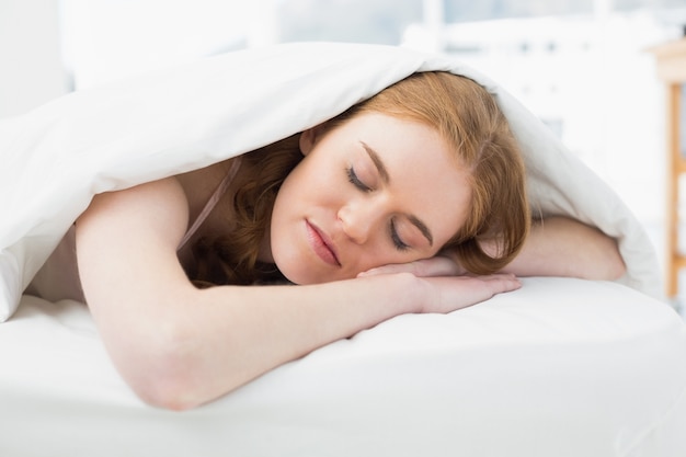 Close up of a pretty woman sleeping in bed