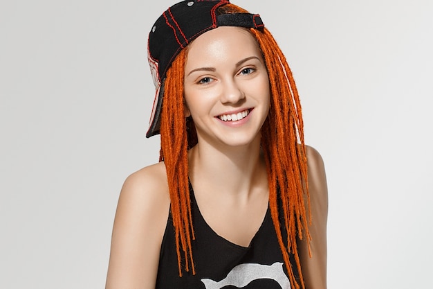 Photo close up pretty young woman face with dreadlocks red hair. studio shot. isolated on white.