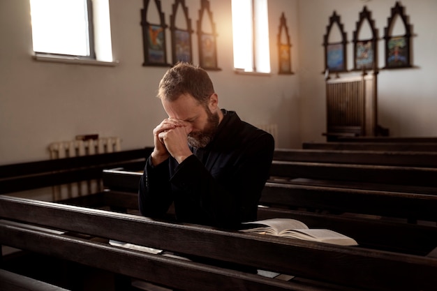 Photo close up on priest reading form the bible