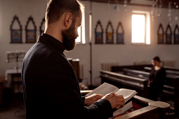 Photo close up on priest reading form the bible