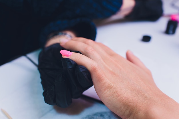 Close up of process france manicure at beauty salon.