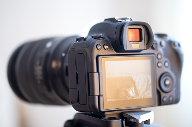 Close up of a professional digital camera on a blurred background