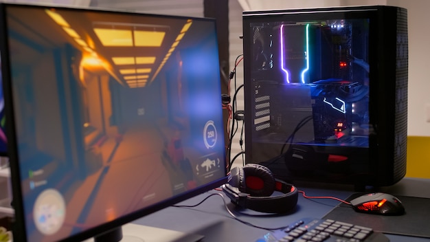 close-up of professional monitor with first person shooter video game on. home studio of esport video game player using powerful gaming computer during online competition
