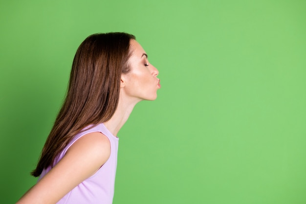 Close-up profile side view portrait of her she nice-looking attractive pretty lovable dreamy girl sending air kiss romance date copy space isolated green color background
