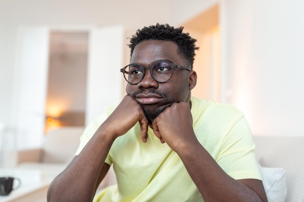 Close up profile view of pensive upset african american man\
look in distance thinking of personal problems thoughtful sad\
biracial male feel depressed lost in thoughts pondering having\
dilemma