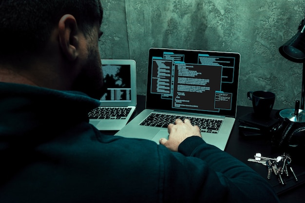 Close up of programmer of hacker hands typing a code