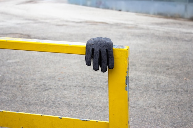 Photo close-up of protective glove on railing