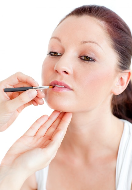 Close-up of a proud woman being made-up by a professional artist