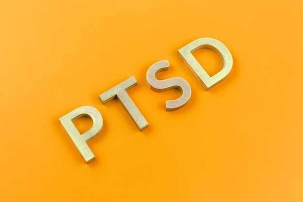 Close-up of ptsd text on orange background