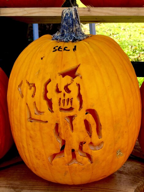 Close-up of pumpkin on stone wall during halloween