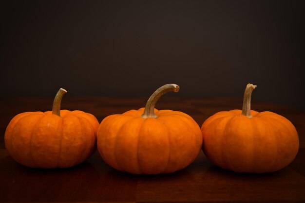 Photo close-up of pumpkins against black background