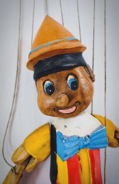 Photo close-up of puppet against white wall