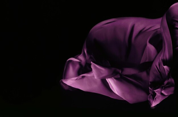 Photo close-up of purple fabric on black background