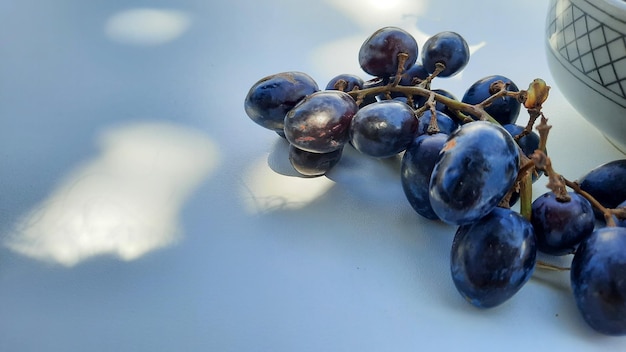 Close up, Purple grapes in bowl with stem isolated on white background 04