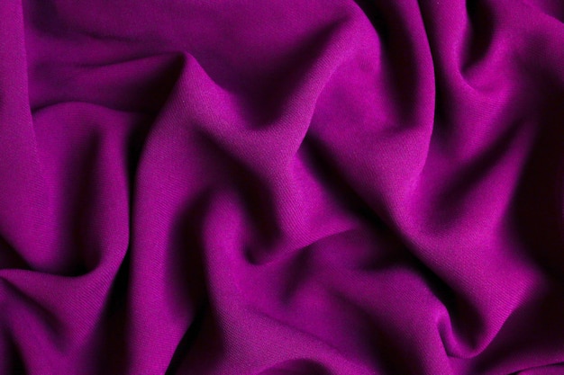 紫のトーンの抽象的なテキスタイルテクスチャ背景をクローズアップ