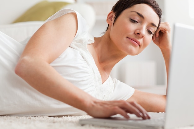 Close up of a quiet woman relaxing with a laptop