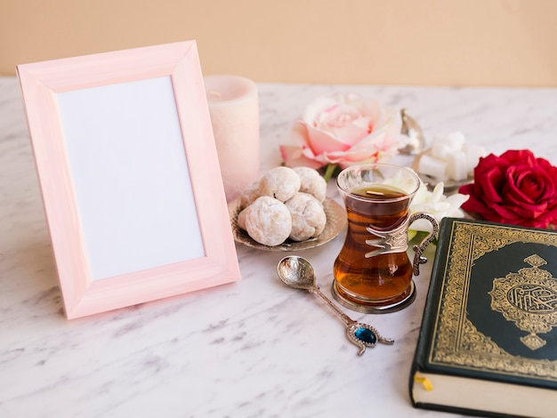 Close up quran on festive table with picture frame