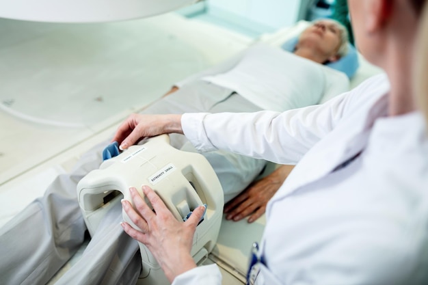 Close up of radiologist preparing a patient for knee MRI scan in the hospital