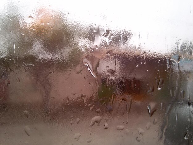 Close-up of rain drops on glass window