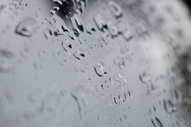 A close up of rain drops on a rearview mirror