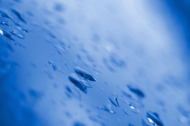 Close-up of raindrops on blue sea