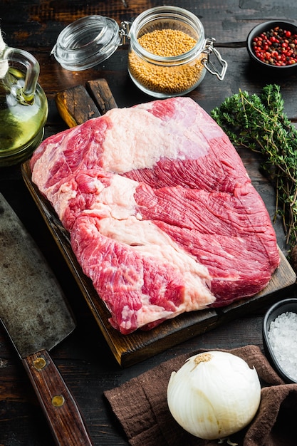 Close up on raw brisket beef meat on wooden table