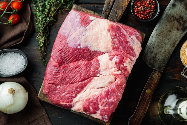 Close up on raw brisket beef meat on wooden table