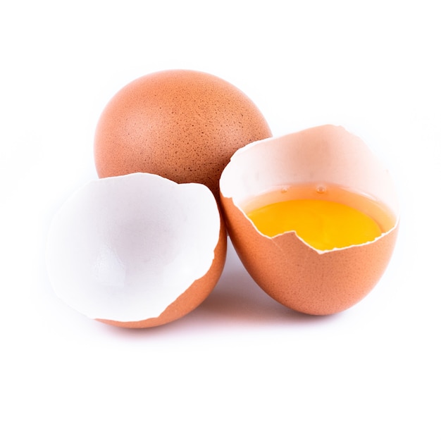 Close up of raw chicken eggs and shell isolated