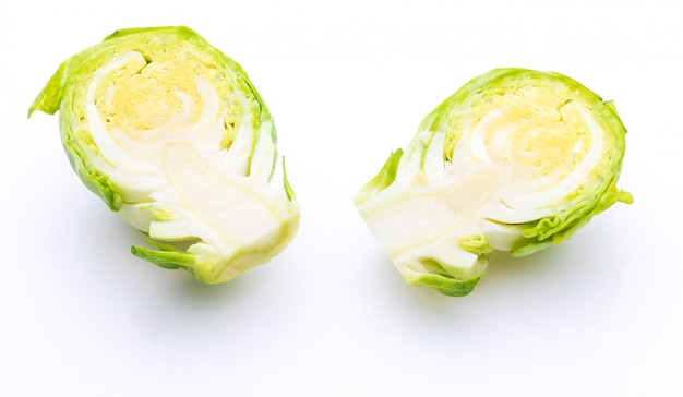 Close-up of raw, fresh brussels sprouts, cut in two halves (cabbages - Brassica oleracea). Isolated on white background.