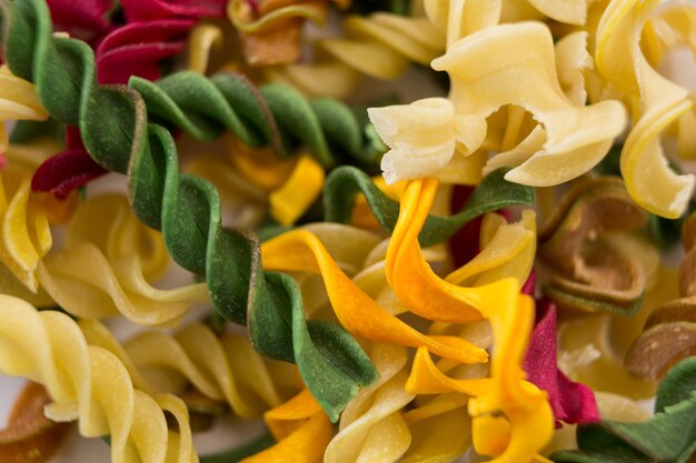 Photo close-up of raw multicolored rotini