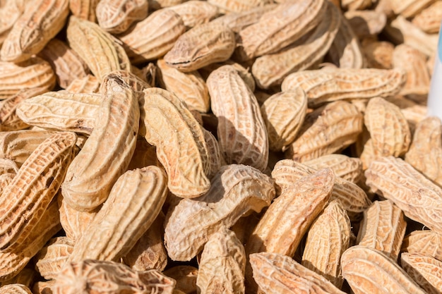 Close up of Raw peanuts in shells background
