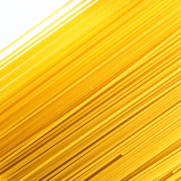 Close-up of raw spaghetti over white background